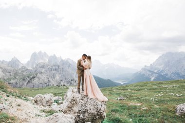 Harika bir gelin damada poz veriyor ve harika manzaralı dağlarda eğleniyor. Mesajlaşacak yer, düğün çifti.