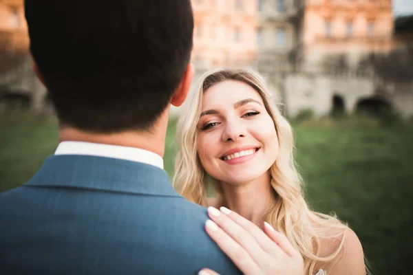 Gorgeous happy couple standing close to each other and looking in eyes — Stock Photo, Image