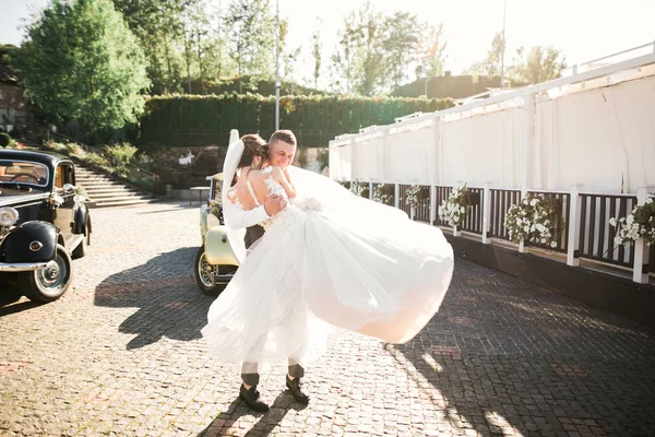 Noiva de casamento e noivo, casal elegante ficar perto de carro de casamento retro — Fotografia de Stock