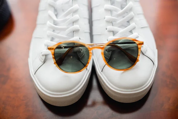 Sunglasses on a white shoes — Stock Photo, Image