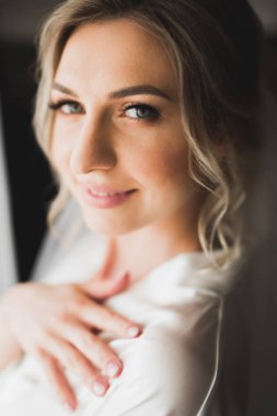 Tüylü, lüks makyaj, saç stili, stüdyo içi fotoğraf çekimi olan güzel bir gelin.