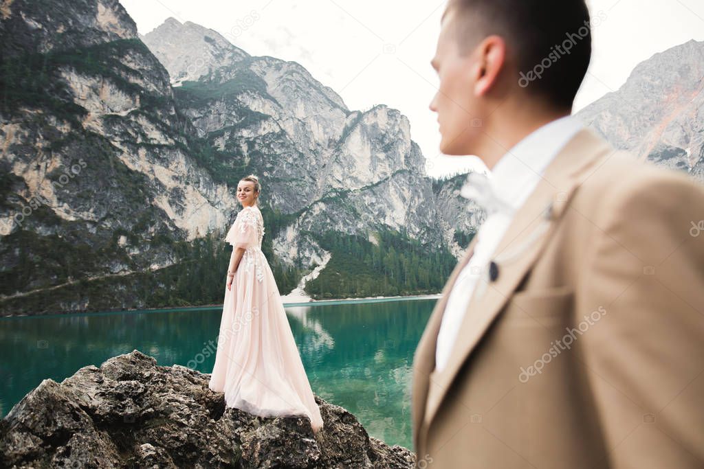 Beautiful modern couple near a lake in the mountains make wedding photos