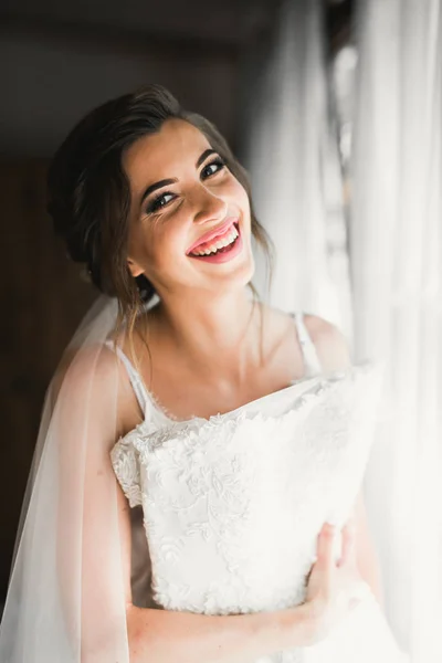 Чудова наречена в халаті позує і готується до весільної церемонії обличчя в кімнаті — стокове фото