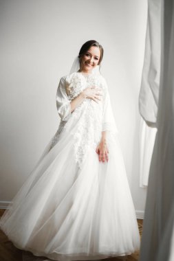 Tüylü, lüks makyaj, saç stili, stüdyo içi fotoğraf çekimi olan güzel bir gelin.