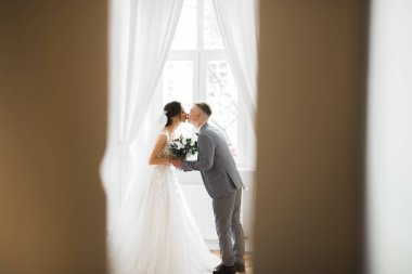 Güzel gelin ve damat evlendikleri gün kucaklaşıp öpüşüyorlar.