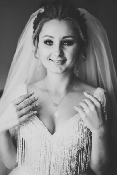 Красивая невеста в модном свадебном платье с перьями с роскошным макияжем и прической, студийная фотосессия — стоковое фото