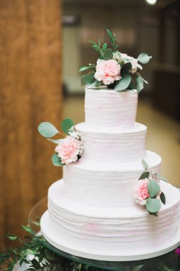 Masada süslü düğün pastası var.