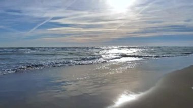 The Beach stock video is a fine piece of video that shows calm beach waves sweeping up the shore on a sunny day. You can use this 1920x1080 (HD) bit of video in any project that has to do with the beach and traveling.