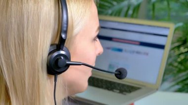 Call Center Employee is a stock video that features amazing footage of female call center agent speaking with a customer on the phone. She is also scrolling through the customer's profile to check what she can offer him.