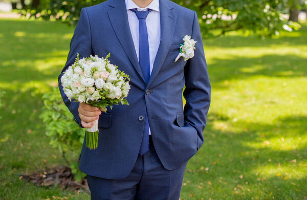 Groom with wedding bouquet