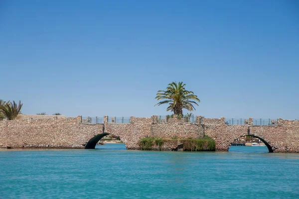 bridge over sea water with blue sky