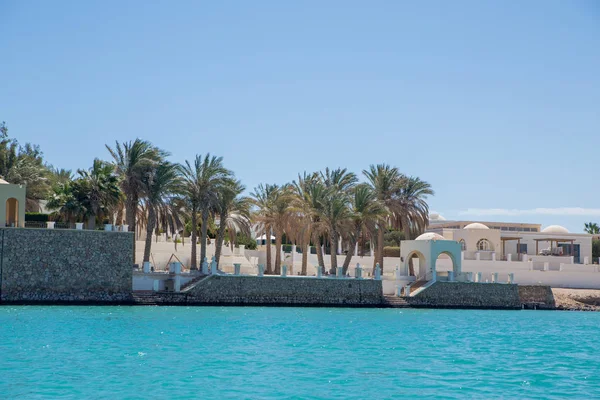 resort buildings between blue sky and sea