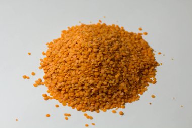 Beyaz arka planda bir yığın mercimek.