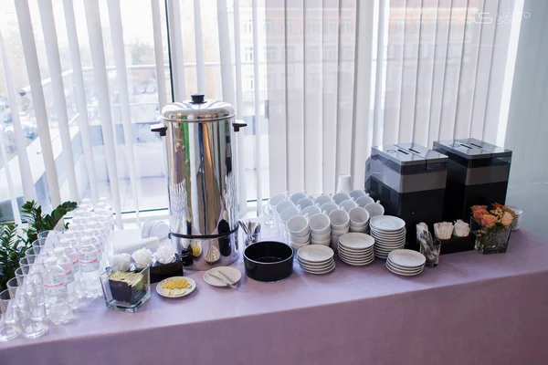 cups of coffee and a teapot at the buffet