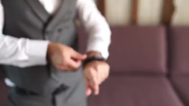 Man Puts Watch His Hand — стоковое видео