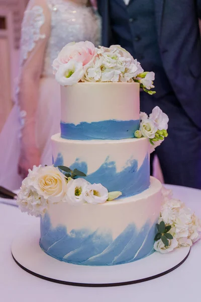 bride and groom cut a wedding cake