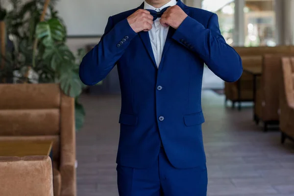 Man Puts Blue Suit Bow Tie — Stock Photo, Image