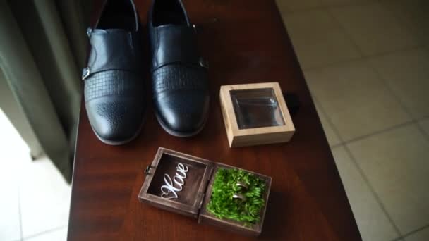 新郎の靴の近くに結婚指輪付きの箱 — ストック動画