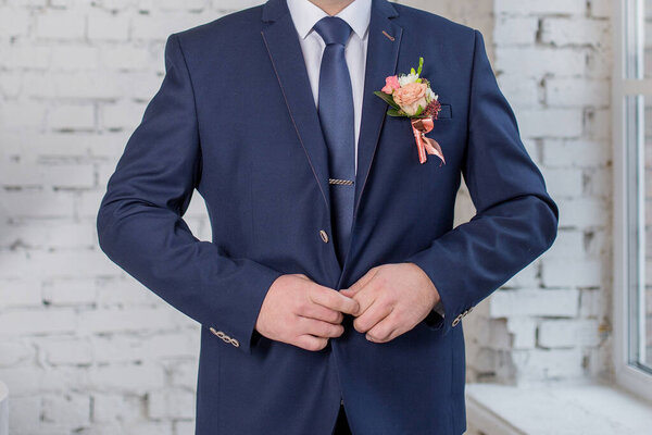groom in wedding suit alone