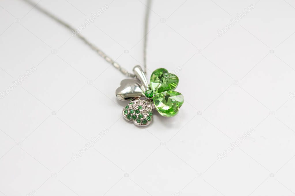 a silver leaf pendant with stones