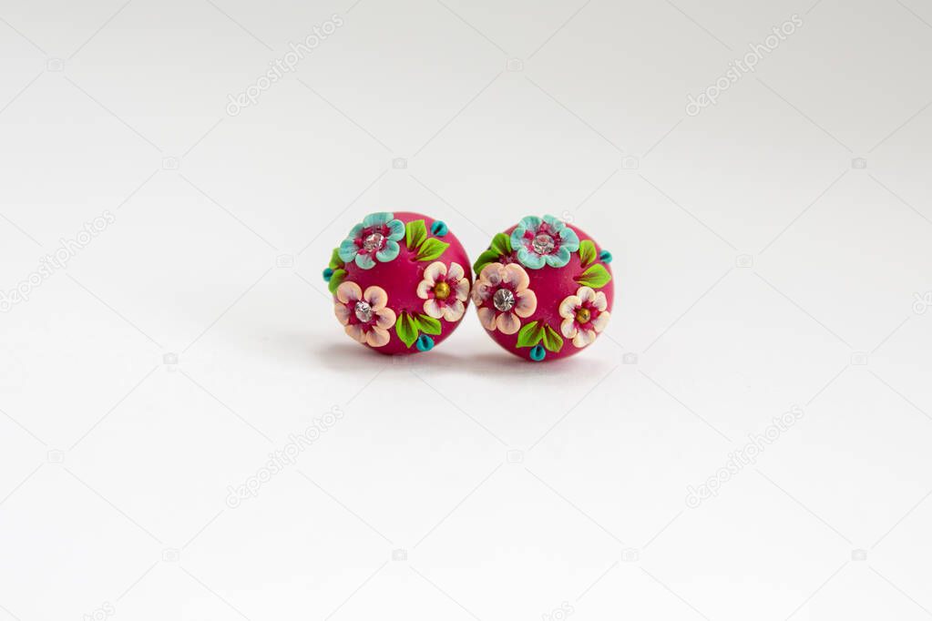 painted red earrings on white background