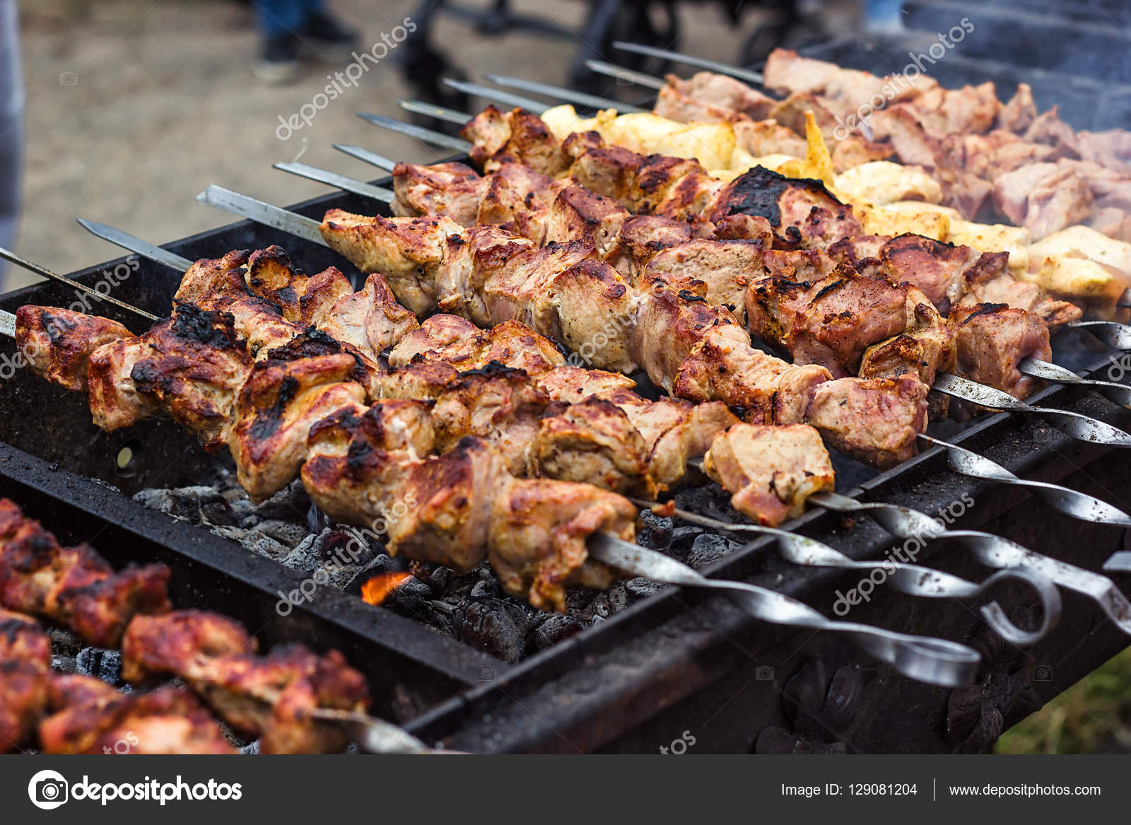 Grilling marinated shashlik on a grill. Shashlik is a form of Shish kebab  popular in Eastern, Central Europe and other places. Shashlyk meaning skewer  Stock Photo - Alamy