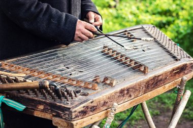Cimbalom very special string wooden musical instrument. A street musician plays a cimbalom. The cimbalom, tambal, hammered dulcimer with player hands, hammers. Ukrainian national instrument folk music clipart