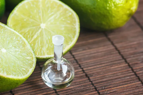 Essential Oils Glass Bottle Fresh Juicy Ripe Limes Beauty Treatment — Stock Photo, Image