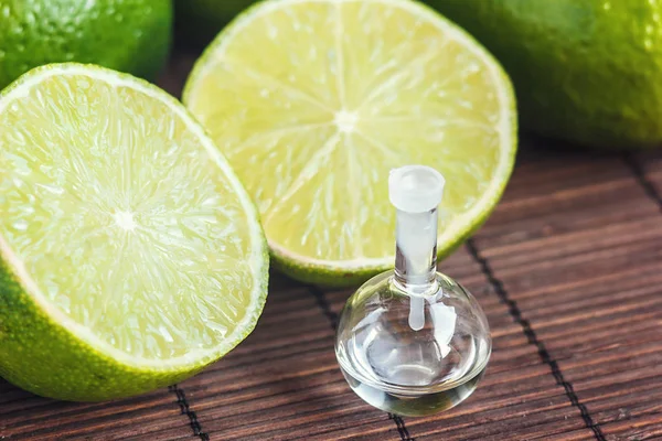 Essential Oils Glass Bottle Fresh Juicy Ripe Limes Beauty Treatment — Stock Photo, Image