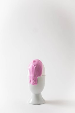 Sıvı boyalı Paskalya yumurtası. Minimalizm kavramı. Beyaz arkaplanda pembe pastel renk