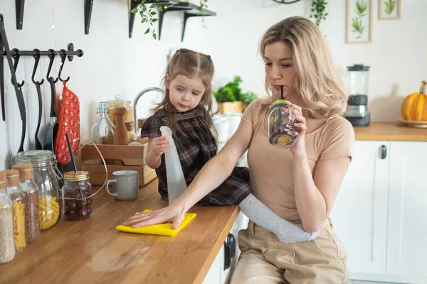 Jeune mère faisant des travaux ménagers à la cuisine avec sa fille tout-petit. Vie domestique — Photo