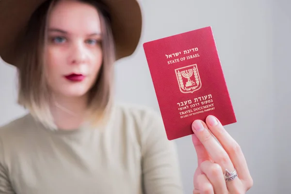 Young woman with Israel travel document passport on white background