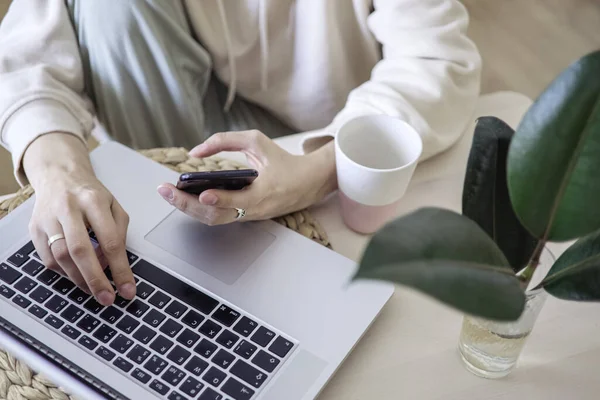 work from home. Distance education, learning. Womans hands typing on laptop at home close up. Selective focus.