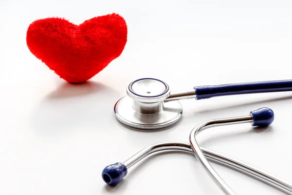 Stethoscope on white background with plush heart — Stock Photo, Image