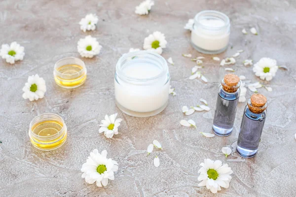 Organic cosmetics with camomile on stone background — Stock Photo, Image