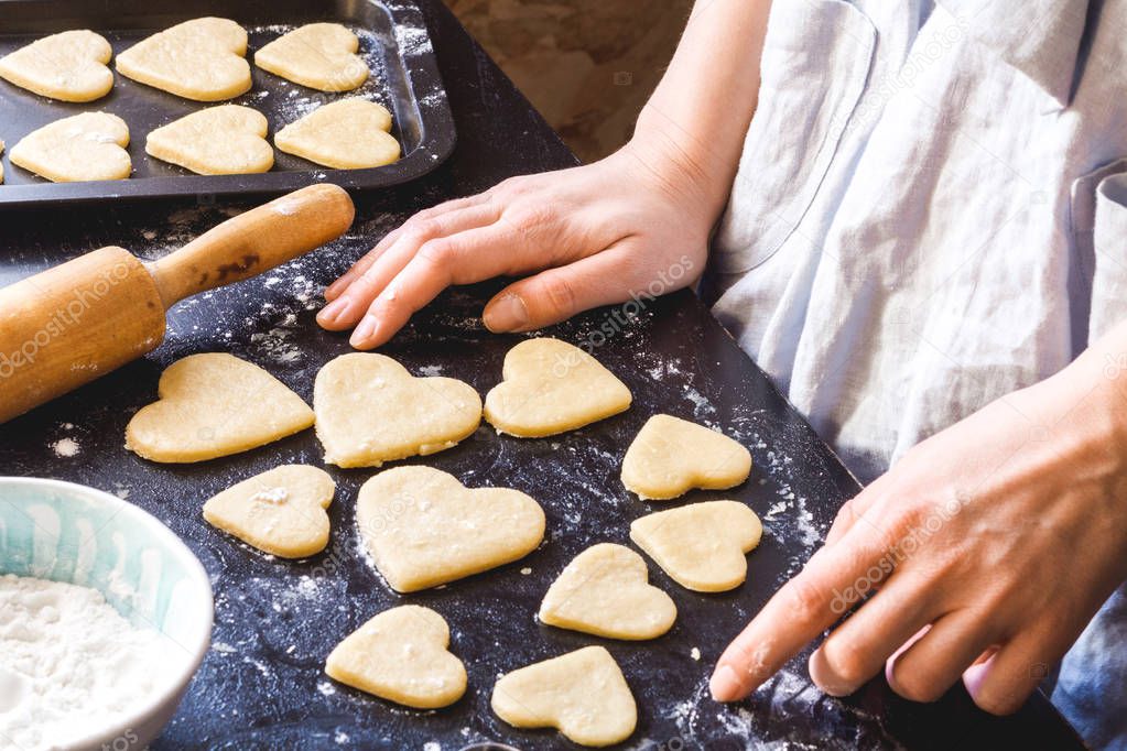 cooking homemade cookies with hands on dark background