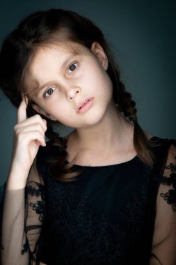 Gri arka planda stüdyo resmi olan güzel bir kız.