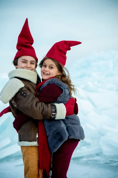 Crianças Sorridentes Bonés Gnomo Vermelho Abraçando Gelo Fundo Inverno — Fotografia de Stock