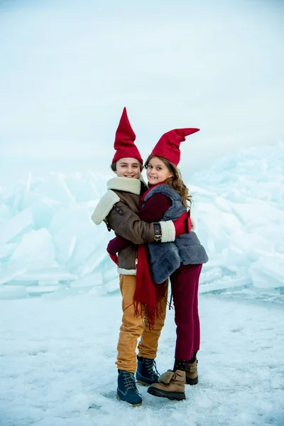 Bambini Sorridenti Cappucci Gnomo Rosso Che Abbracciano Sul Ghiaccio Sullo — Foto Stock