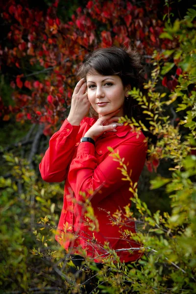 美しい女性が赤いシャツを着て屋外でポーズ — ストック写真