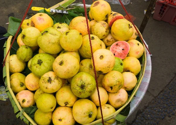 Venta de guayabas rojas maduras en una canasta de bambú foto tomada en Depok Indonesia — Foto de Stock