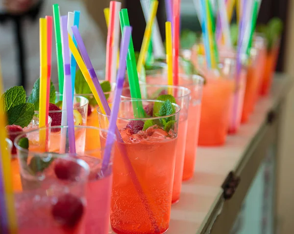Non-alcoholic cocktails. Fruit and berry cocktails with colored tubules. Fitness Bar