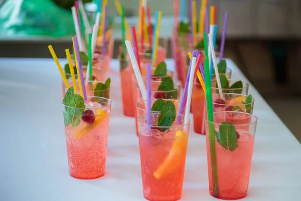 Non-alcoholic cocktails. Fruit and berry cocktails with colored tubules. Fitness Bar
