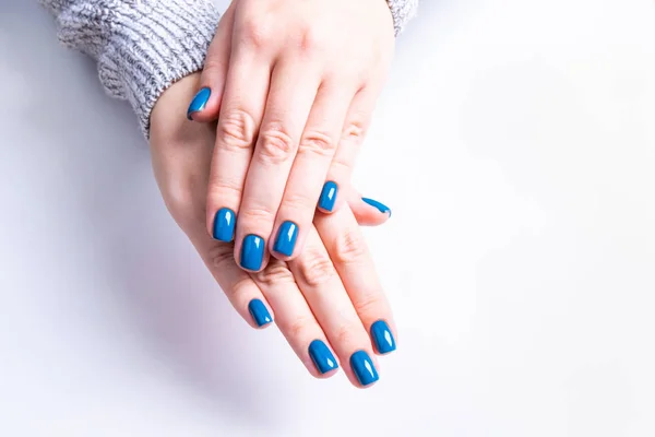 Stylish women\'s blue manicure. Beautiful girl hands