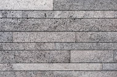 Arka plan olarak köpüklü betondan yapılmış briketin yüzeyindeki soyut desen. Betonun hücresel dokusu.