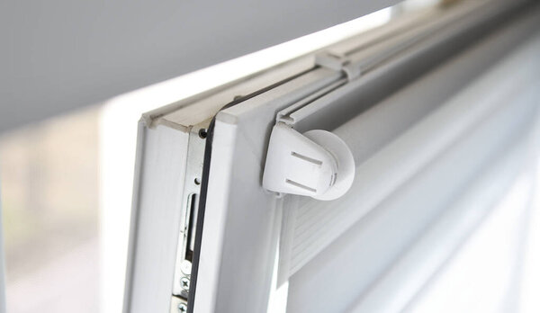 View of a dirty window with roller blinds from above.