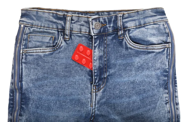 Pack of pills in the fly of blue jeans on a white background. Sexual diseases. Sexually transmitted diseases.Birth control in jeans pocket, closeup. Safe sex concept. — Stock Image Pack Pills Fly Blue Jeans White Background Sexual Diseases Sexually Stock Photo