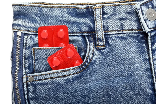 Pack of pills in the fly of blue jeans on a white background. Sexual diseases. Sexually transmitted diseases.Birth control in jeans pocket, closeup. Safe sex concept. — Stock Image Pack Pills Fly Blue Jeans White Background Sexual Diseases Sexually Stock Picture