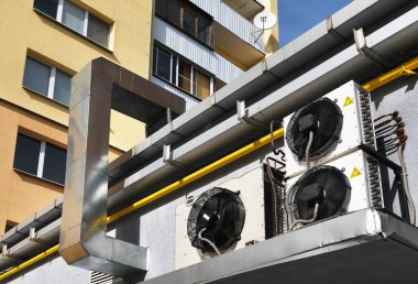Isı değiştirici. Binanın duvarında havalandırma sistemi var. Yakınlarda klima var..