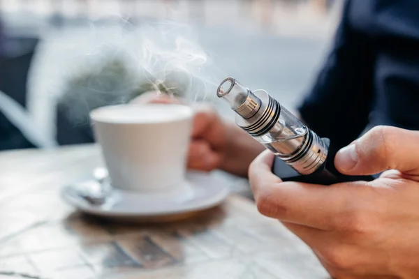 vape veya elektronik sigara ve kahve içme adam